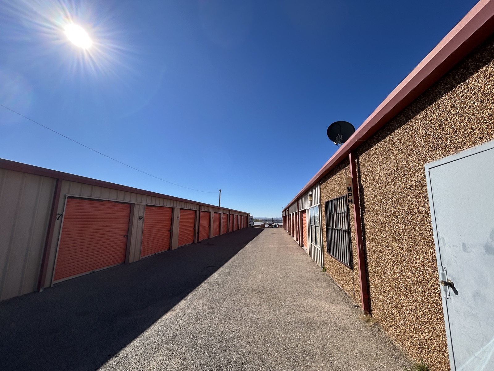 Wide driveway between storage unit buildings with easy access
